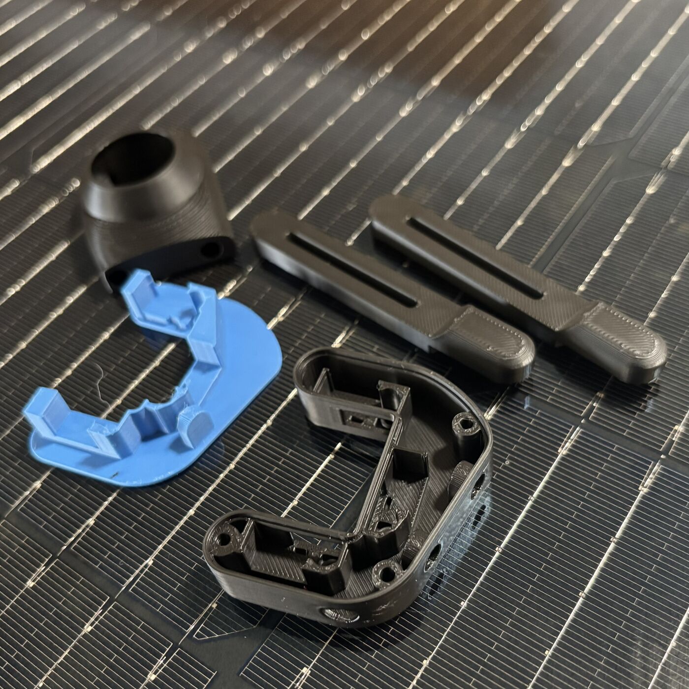 Assorted 3D-printed replacement components and brackets